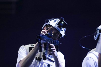 Player aiming through red dot sight in white helmet