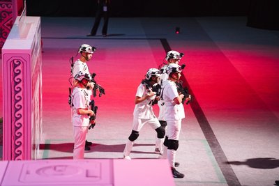 Team in white gear on arena under spotlights