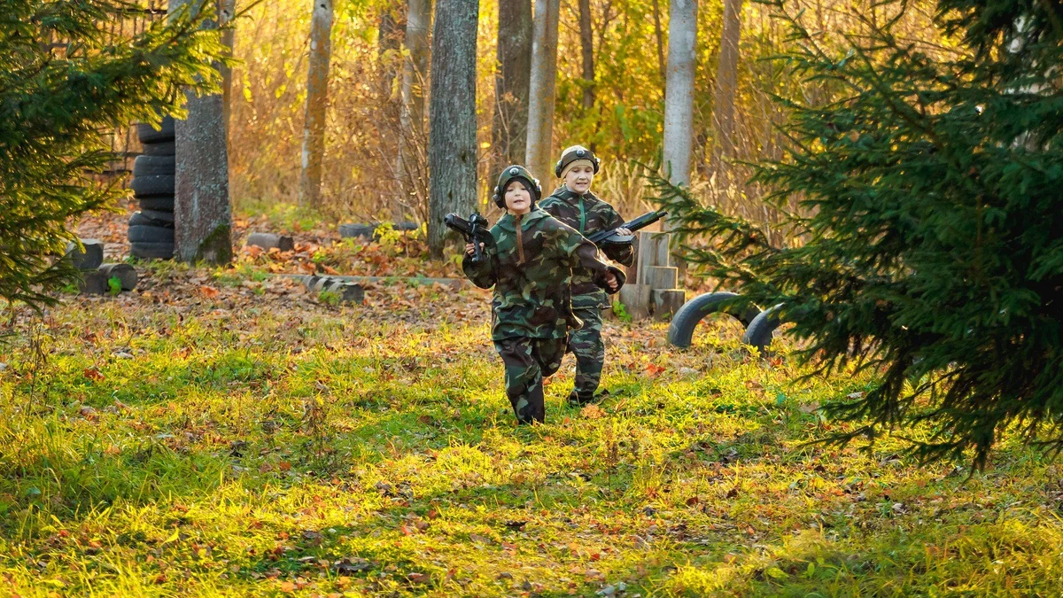Laser tag players running through a forest playing field